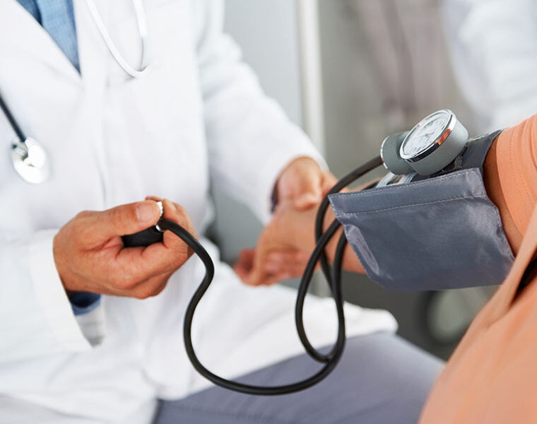 doctor taking blood pressure of a patient