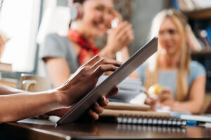 cropped shot of woman using digital tablet on tabletop