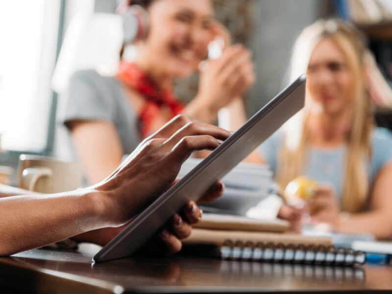 cropped shot of woman using digital tablet on tabletop