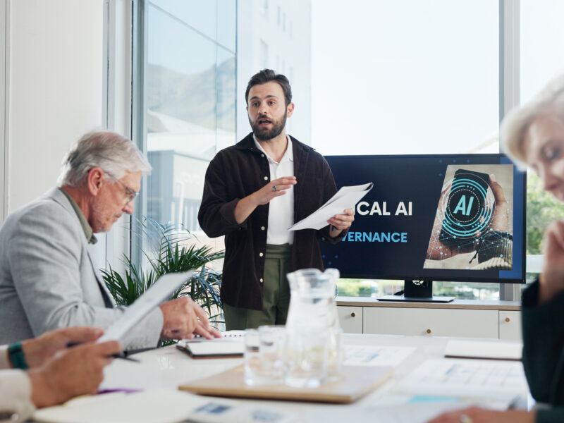Businessman in office with team discussing AI