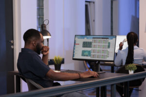 Trading manager looking at stock market exchange statistics