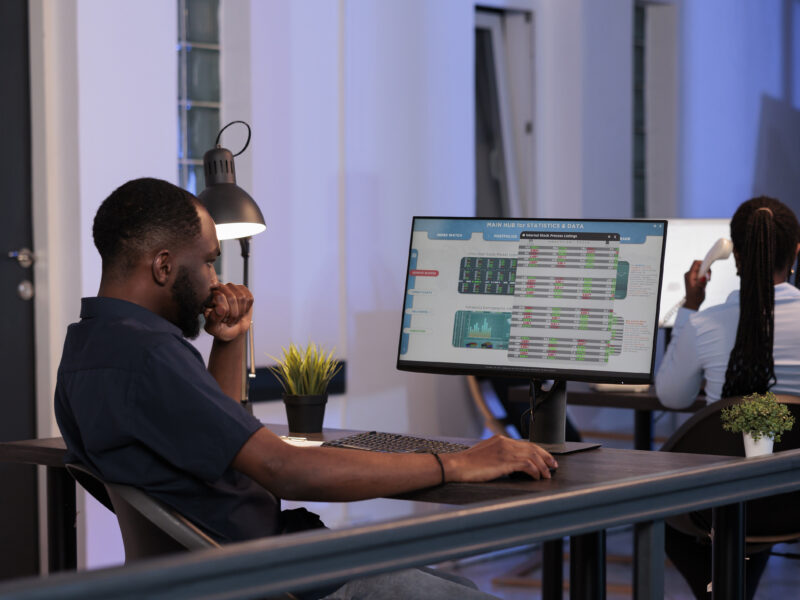 Trading manager looking at stock market exchange statistics