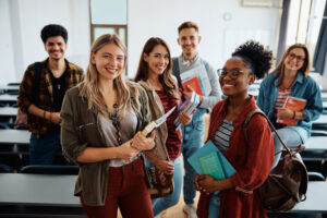 Smiling students in the classroom looking at camera.