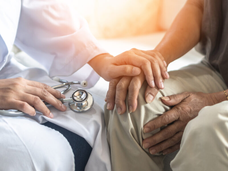 Hand and knee pain or mental health care concept with geriatric doctor consulting examining elderly senior aged adult in medical exam clinic or hospital.