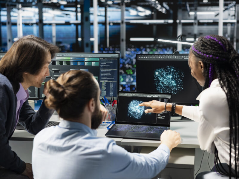 Coworkers doing brainstorming, monitoring AI applications
