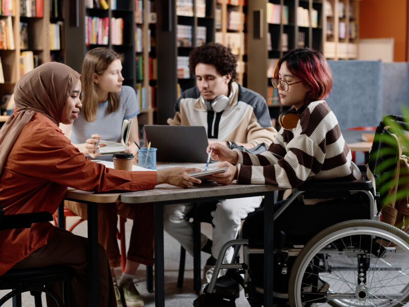 Diverse Students Studying In Library