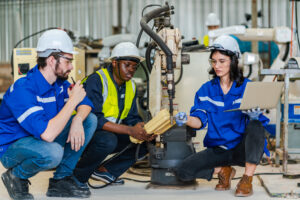 Group of various national engineer professional successful team corporate workers standing in factory, teamwork technician inspector of manufacturing industry workplace, foreman occupation job