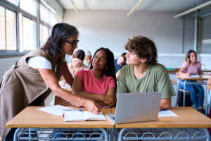 Teacher helping students in class
