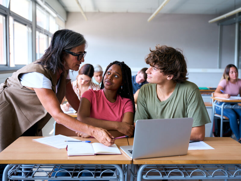 Teacher helping students in class