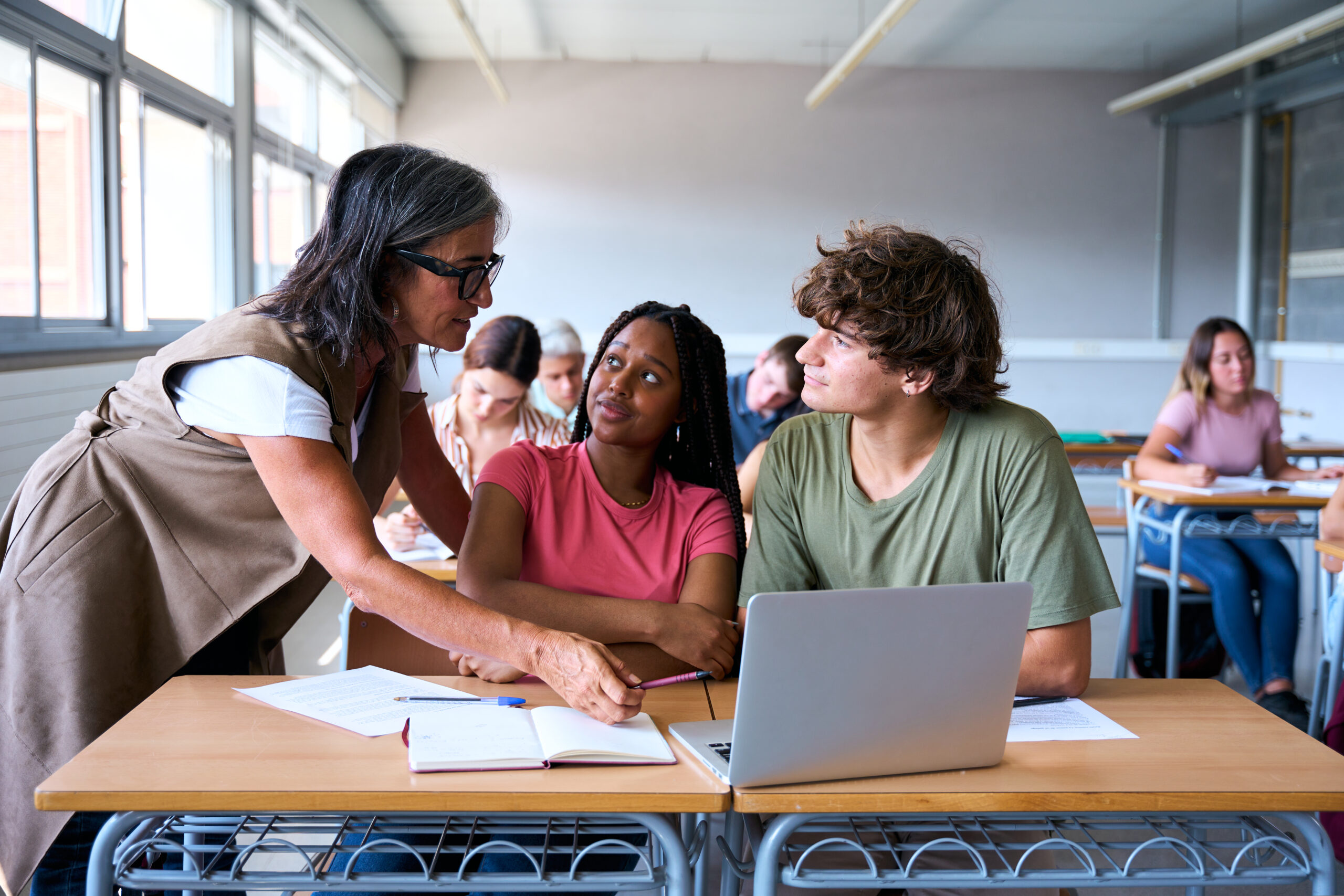 Teacher helping students in class