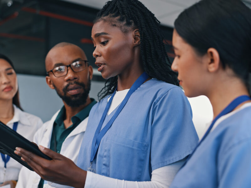 Medical team, tablet and discussion in a hospital with doctor, meeting and planning at work.