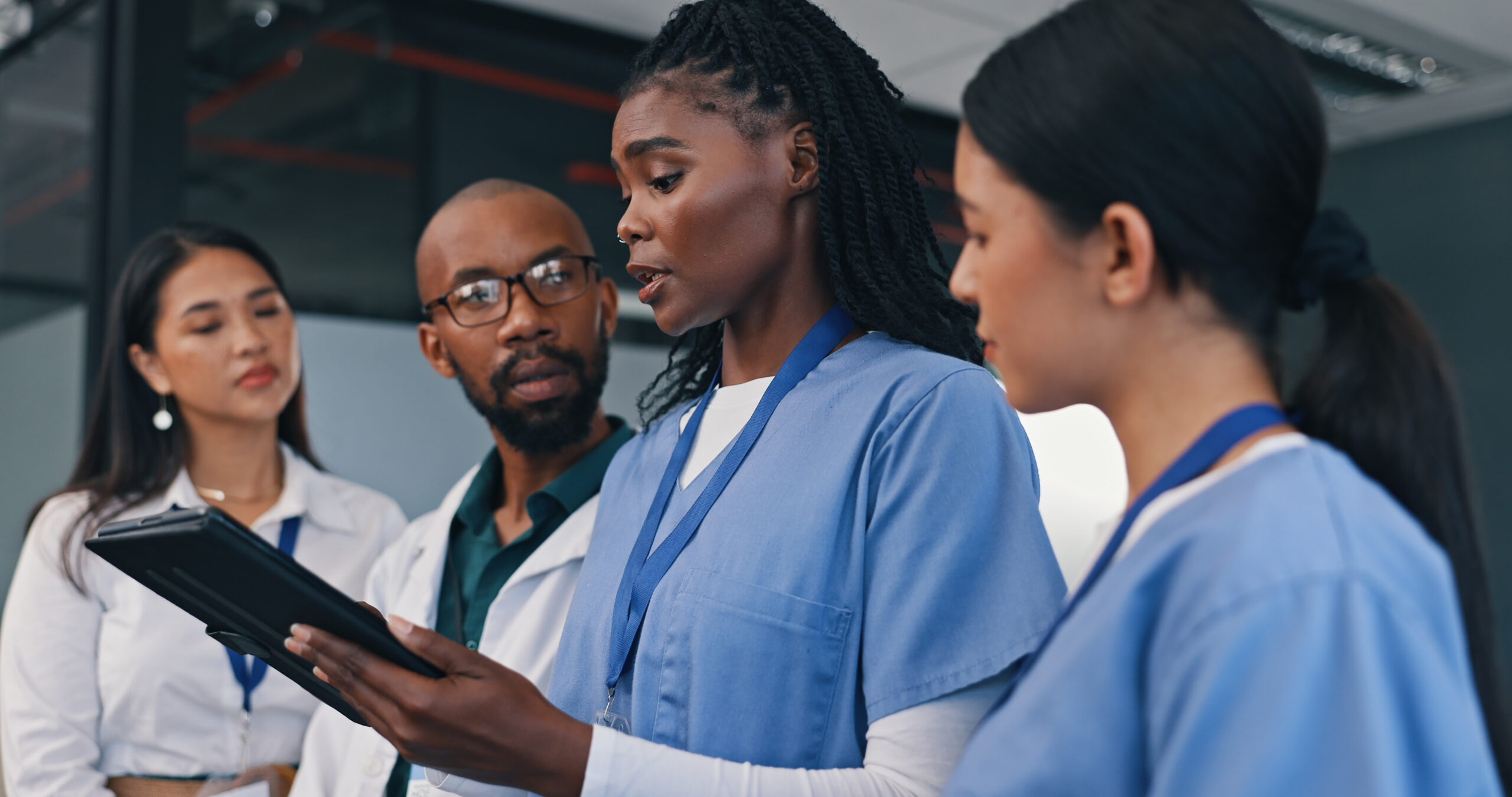 Medical team, tablet and discussion in a hospital with doctor, meeting and planning at work.