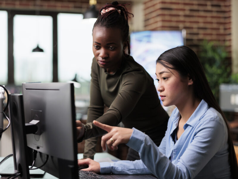 Creative and diverse office people reviewing 3D project progress while solving graphical issues.
